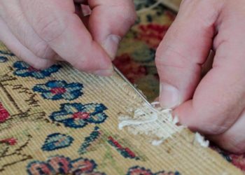 handyman restorating a carpet